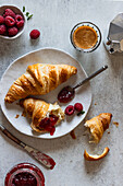 Breakfast with croissants, jam, raspberries and espresso