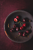 Fresh sweet cherries in a clay dish