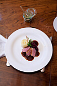 Duck with onion sauce, red cabbage and mashed potatoes