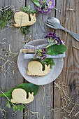 Napkin with primroses (alpine auricel), leaf as name card, snail-shaped cookies, table decoration