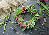 Wreath made of pasque flower (Pulsatilla), forget-me-not, daisies (Bellis) and birch twigs