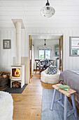 Open-plan living room with white wood-burning stove and country-style dining area