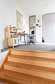 Children's kitchen, work area with desk, chair and stool in the corner of a bright room