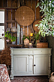 Rustic chest of drawers with decoration and plants