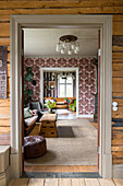 Entrance area with view of living room with patterned wallpaper and vintage furniture