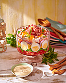 Layered salad with ham and boiled egg