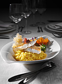 Pike-perch with the skin fried with saffron risotto and zucchini flower