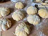 Stuffed mini pumpkin pies made from yeast dough for Halloween (unbaked)