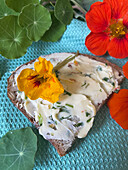 Bread with herb butter and nasturtium flowers