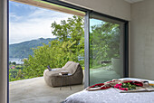 Beanbag on the terrace, bed in bedroom with lake view