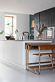 Modern kitchen with black wall cabinet and white kitchen island