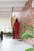 Hanging staircase and brick wall in modern living room