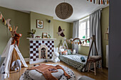 Children's room with fireplace, teepee tent and animal motifs