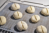 Cut bread roll dough on cookie sheet\n