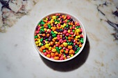 Still life of vibrant, multicolored candy in bowl\n