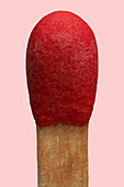 Close up red matchstick on pink background\n