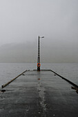 Wet jetty at foggy ocean, Kollafjorour, Faroe Islands\n