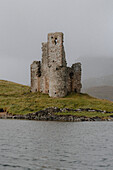 Castle ruins at water's edge, Assynt, Sutherland, Scotland\n