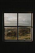 Sunlight in window overlooking grassy landscape, Rubha Hunish, Isle of Skye, Scotland\n