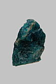 Close up green textured Madagascan apatite stone on gray background\n