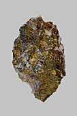 Close up gold German chalcopyrite stone on gray background\n