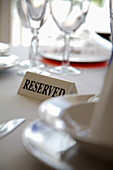 Extreme close up of tableware and reserved sign\n