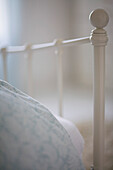 Close up of bed and white bed frame\n