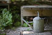 Summer garden and metal watering can\n