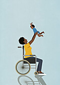 Happy mother in wheelchair playing with excited baby son, holding overhead\n
