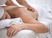 Woman receiving a back and shoulder massage\n