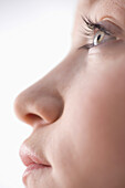 Extreme close up of young woman mouth nose and eye\n