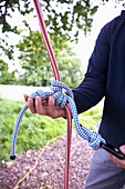 Close up of climber hands holding and checking climbing rope\n