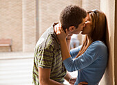 Portrait of young couple kissing\n