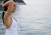 Portrait of young woman standing on beach\n