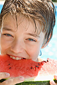Young boy eating water melon\n