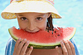 Young girl eating water melon\n