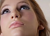 Extreme close up of beautiful young woman looking up\n