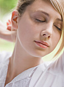 Close up of young woman with eyes closed\n