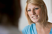 Close up of a young woman talking and smiling\n