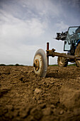 Agricultural field with tractor\n