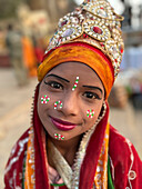 Head and shoulders portrait of painted girl, Varanasi, Uttar Pradesh, India\n