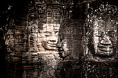 Ancient faces carved in stone at Bayon temple, Angkor Wat, UNESCO World Heritage Site, Cambodia, Indochina, Southeast Asia, Asia\n