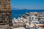 View of sea and whitewashed buildings and rooftops of Mandraki, Mandraki, Nisyros, Dodecanese, Greek Islands, Greece, Europe\n