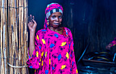 Portrait of a local woman in bright pink clothes, Lake Chad, Chad, Africa\n