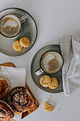 Coffee with freshly baked cookies on table\n