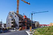 View of construction site with building crane against blue sky\n