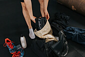 Person packing equipment after workout in gym\n