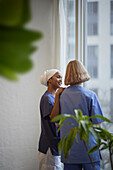 Female doctors standing and talking at hospital corridor\n