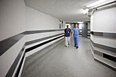 Female doctors walking through hospital corridor\n