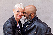 Portrait of cool mature biker couple in leather clothes\n